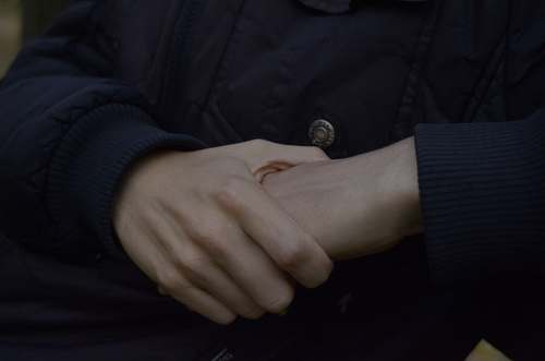 holding hands person wearing black top grey